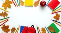 Back to school flat lay with colorful pencils, notebooks, apple and autumn leaves arranged in circle frame on white background for educational design.