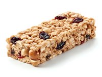 Homemade granola bar with oats, dried cranberries and peanuts on white background, healthy snack for energy boost during outdoor activities.