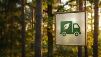 Green delivery truck icon sign in autumn forest setting with golden sunlight filtering through trees for eco-friendly logistics and sustainable transport.