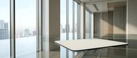 Modern minimalist office conference room with large windows overlooking city skyline. Clean white table and polished floors create professional workspace.