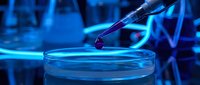 Scientist pipetting liquid sample into petri dish in laboratory with blue neon lighting and molecular structure background, suitable for biotech and research visuals.