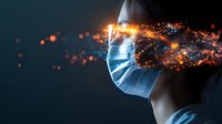Medical face mask with glowing orange particles and sparks dispersing in dark background, side view profile highlighting protection and healthcare concept.