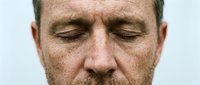 Middle-aged Caucasian man with closed eyes and relaxed facial expression, displaying calm, peaceful, or meditative state for wellness and mental health concepts.