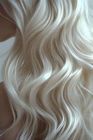 Platinum blonde wavy hair texture closeup showing soft flowing curves and highlights against neutral background. For beauty, fashion and hair care advertising.