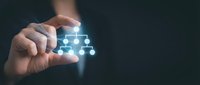 Businessman hand holding smartphone displaying glowing network pyramid structure with connected nodes and data flow visualization for business growth and digital transformation.