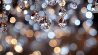 Elegant crystal chandelier with sparkling glass beads creating beautiful bokeh light effects for luxury interior design and home decor projects.