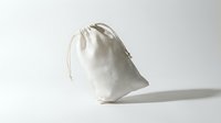 Natural cotton drawstring pouch bag isolated on white background for eco-friendly packaging, storage and promotional gifts in minimalist style.
