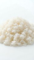 Pile of cooked white rice grains isolated on white background, suitable for food packaging, culinary websites, restaurant menus, and cooking blogs.