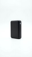 Compact black portable power bank with rounded corners isolated on white background, ready for product design, marketing materials, and tech accessory presentations.