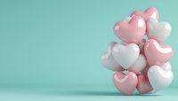 Heart-shaped pink and white balloons arranged in cluster against mint green background, romantic celebration concept with copy space for text.