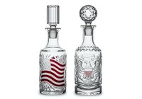Pair of vintage crystal decanters with stoppers, one featuring red wavy stripes and ornate detailing, isolated on white background for design use.