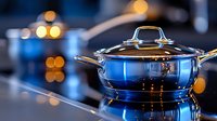 Shiny stainless steel cooking pot with lid on glass cooktop surface, reflecting blue light and bokeh effects in modern kitchen setting. Professional cookware.