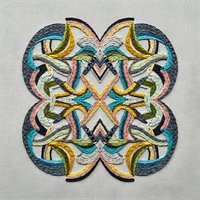 Colorful mandala embroidery design with intricate geometric patterns and vibrant threads on fabric background for textile and craft projects.