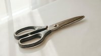 Vintage metal scissors with black handles isolated on white background, ready for craft, sewing, and design projects.
