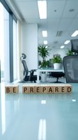 Be prepared wooden blocks on modern office desk with blurred workspace background, symbolizing readiness and business planning for corporate environments.