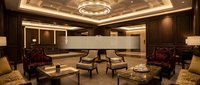 Luxury hotel lobby interior with elegant seating area, warm lighting, modern chandelier and sophisticated brown wood paneling for hospitality design.