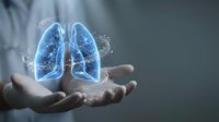 Healthcare professional displaying holographic lungs with digital particles for medical technology and respiratory health concepts.