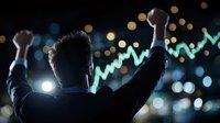 Silhouette of successful trader celebrating with raised arms against glowing stock market chart and city bokeh lights in dark background.