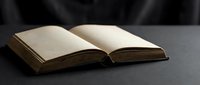 Vintage open book with aged yellowed pages on dark surface creating atmospheric reading and education concept for literary projects and academic materials.
