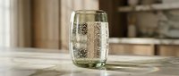 Clear glass filled with sparkling water and bubbles on wooden table in modern kitchen interior for healthy lifestyle and hydration concepts.