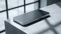 Modern black smartphone lying on concrete surface with dramatic window shadow patterns creating geometric light and dark contrast for technology concepts.