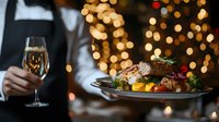 Elegant Christmas dinner with roasted meat, vegetables and champagne glass against warm bokeh lights background for holiday celebration dining.