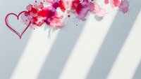 Watercolor heart with pink and red paint splashes on white background with natural shadow stripes. Romantic love concept for Valentine's Day cards and designs.