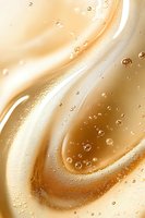 Swirling golden liquid with bubbles and creamy waves creates luxurious abstract background pattern, suitable for cosmetic and beauty product advertising.