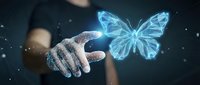 Glowing blue holographic butterfly emerging from outstretched hand against dark background with sparkling light effects for digital transformation concepts.