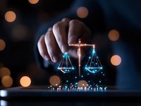 Glowing digital scales of justice with blue light effect and bokeh background, hand holding balance symbol representing law and technology integration.