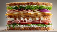 Layered club sandwich with ham, turkey, cheese, lettuce, tomato, and onion on toasted multigrain bread, showcasing vibrant ingredients for food service.