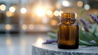 Amber glass bottle with lavender sprigs on concrete surface against blurred bokeh background, moody atmospheric lighting creates spa-like wellness ambiance.