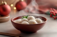 Steaming hot dumplings in brown ceramic bowl garnished with fresh herbs, festive Christmas decorations and red ornaments in background.