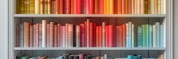 Colorful books arranged by spectrum colors on wooden shelves creating rainbow effect in library or bookstore, modern interior design element for reading space.