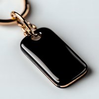 Elegant black enamel keychain with rose gold metal trim on white background, close-up view showing luxurious finish and minimalist design details.