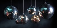 Shiny disco balls hanging against dark background, reflecting colorful lights for nightclub, party or dance floor atmosphere.