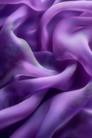 Flowing purple silk fabric with elegant curves and soft shadows creating luxurious textile waves for fashion and interior design projects.