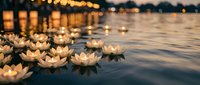 Floating lotus candles on calm water at dusk create peaceful ambiance with warm golden bokeh lights reflecting on surface for meditation and relaxation ceremonies.
