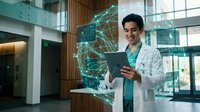 Young Hispanic male doctor in white coat using tablet with glowing AI network hologram in modern hospital lobby, representing digital healthcare innovation.