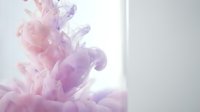 Purple and pink ink clouds swirling in clear water creating abstract fluid motion patterns for creative design projects and artistic backgrounds.