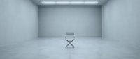 Minimalist director chair in empty concrete studio space with overhead lighting, suitable for film production, casting, and creative industry concepts.