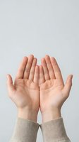 Open cupped hands gesture showing palms up in receiving position against neutral background for charity donation prayer concepts.