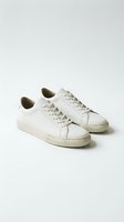 White leather sneakers pair isolated on neutral background for fashion and footwear design projects.