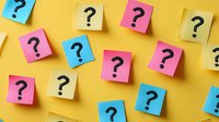 Colorful sticky notes with question marks scattered on yellow background for brainstorming, problem solving and decision making concepts in business presentations.