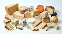 Assorted gourmet cheese collection featuring hard, soft, aged varieties with different textures and flavors for culinary photography and food styling.