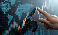 Businessman analyzing financial data on digital screen with candlestick charts and world map for investment strategy and market research.
