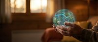 Elderly hands holding glowing Earth globe in warm indoor setting symbolizing environmental care, sustainability, and global responsibility for future generations.