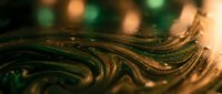 Abstract golden green fluid waves with bokeh lights creating luxurious liquid metal texture for modern digital art and premium design backgrounds.