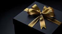 Luxury black gift box with golden ribbon bow on dark background, perfect for holiday, birthday, and special occasion designs.
