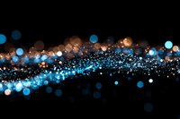Abstract glowing blue and golden bokeh lights flowing on black background, creating magical sparkle effect with blurred particles and luminous wave motion.
